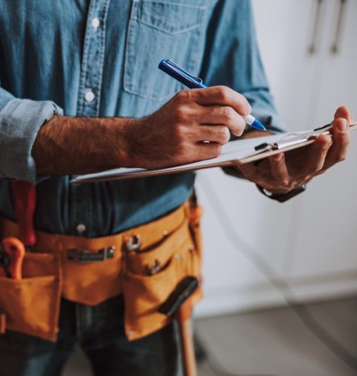 Construction worker writing on clipboard stock photo Image