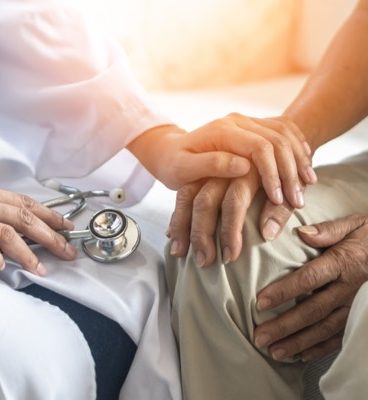 Parkinsons disease patient Arthritis hand gout knee pain or mental health care with geriatric doctor consulting examining comforting elderly senior aged adult in medical exam clinic or hospital Image